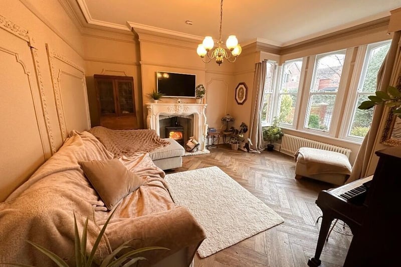 Another lovely bright room with feature fireplace and wooden flooring.