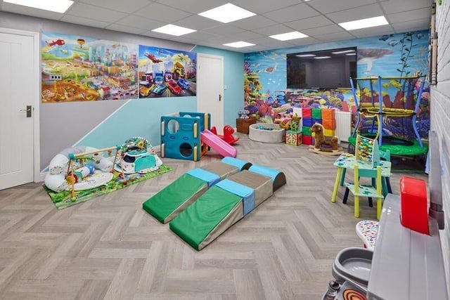 A versatile room with Karndean herringbone flooring, that is currently used as a playroom.