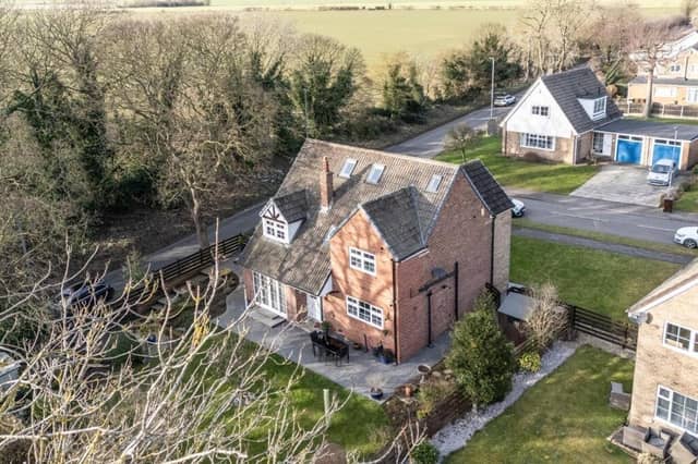 An aerial view of the detached property and its surroundings.