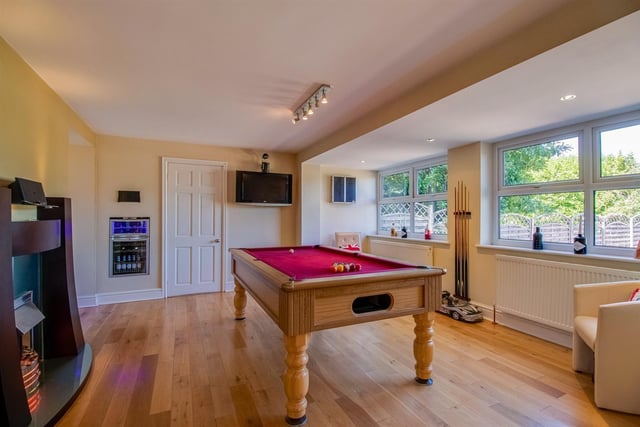 A fireplace with electric fire and inbuilt fridge add to the games room facilities.