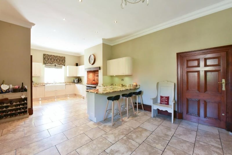 The kitchen also features a stunning natural stone floor.