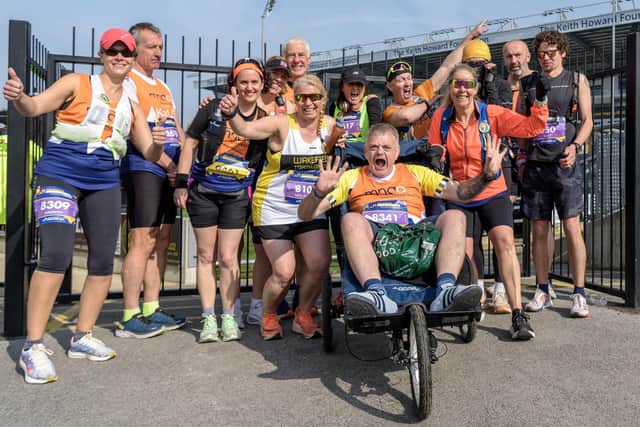 Dale Crowther was pushed around the Leeds Marathon course by friends and members of Wakefield Triathlon Club. Picture: Christopher Cox