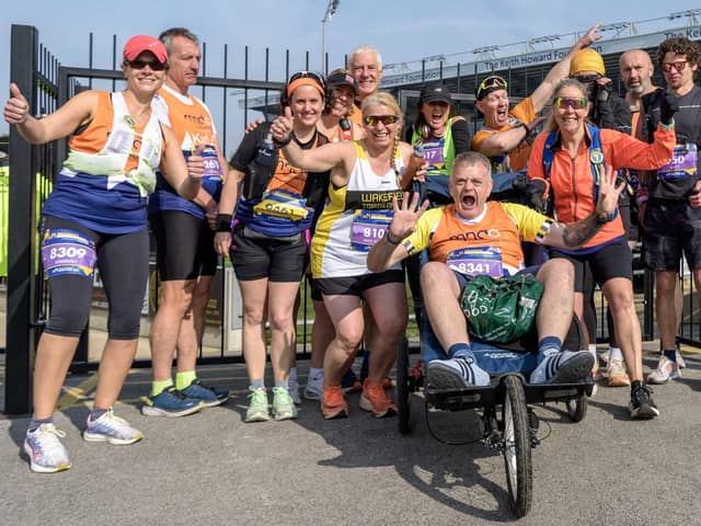 Dale Crowther was pushed around the Leeds Marathon course by friends and members of Wakefield Triathlon Club. Picture: Christopher Cox