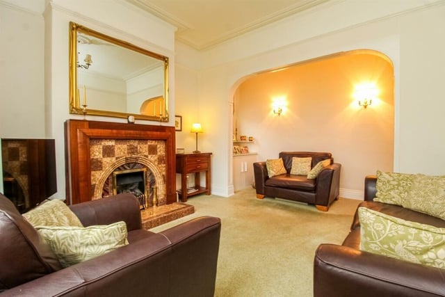 The sitting room includes a central heating radiator, coving to the ceiling, a picture rail, a stained UPVC double glazed sash bay window to the front and an open fireplace with a tiled hearth surround and mantle.