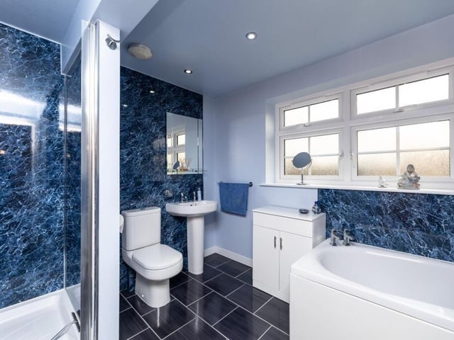 A house bathroom with both bath and shower unit.