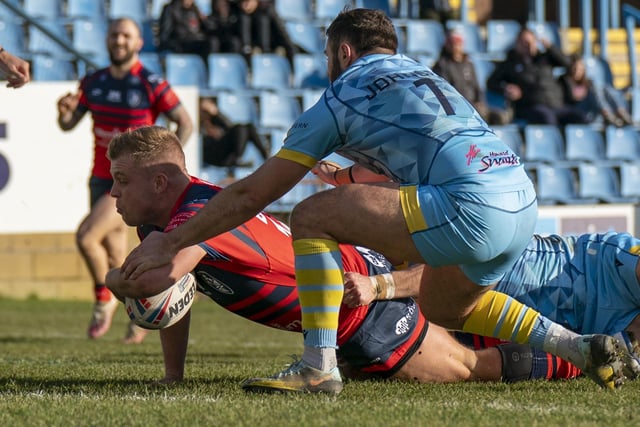 Jack Bussey dives in for one of his two tries for Featherstone Rovers.