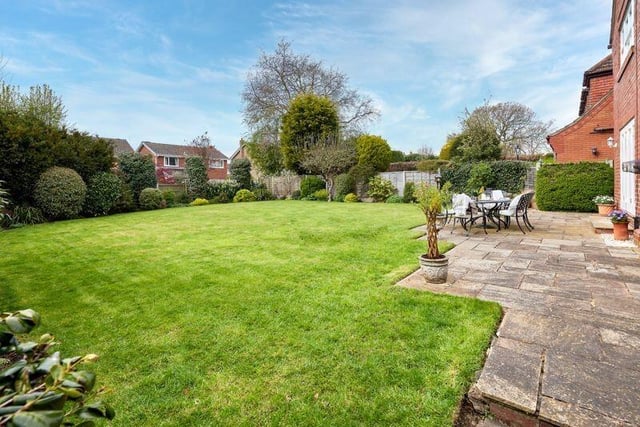 A good size rear garden with lawn and patio seating area.