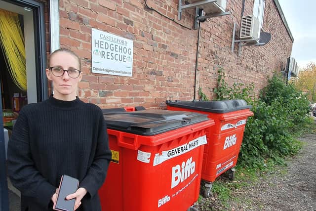 Beth Campsill pictured next to two of the bins at the back of Castleford Hedgehog Rescue