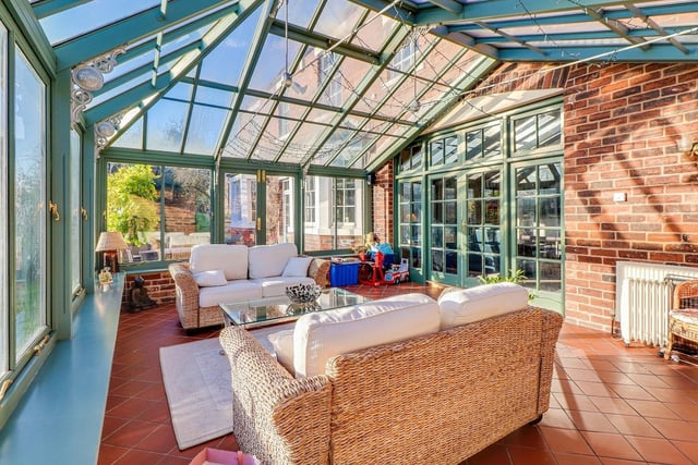 The Amdega conservatory is a spacious room with French doors leading out to the gardens.