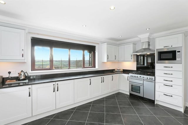 The well-appointed kitchen features a range of white fronted wall and base units, contrasting granite worktops and dual aspect double glazed windows, which make the most of the amazing views.