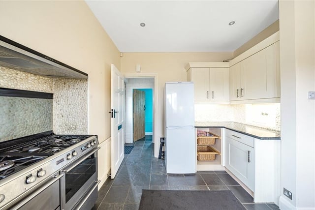 The kitchen is fitted with shaker style wall and base units, with a Belfast style sink.