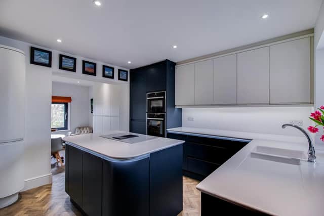 The contemporary style kitchen with integrated appliances has Karndean flooring.