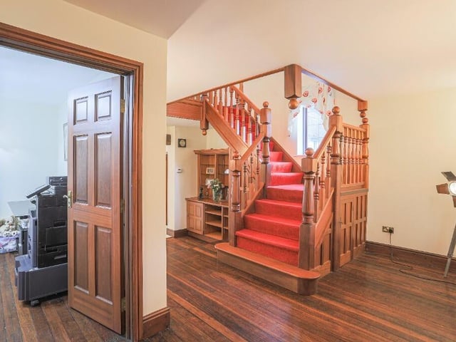 A spacious hallway with staircase up.