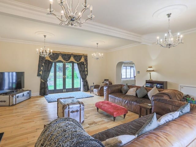 A large reception room with French doors out to the garden.
