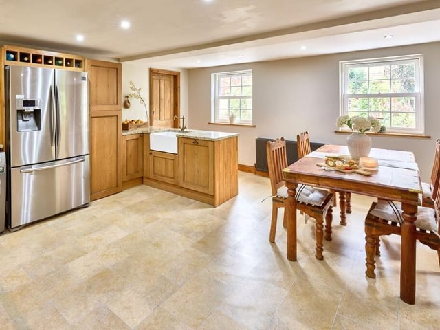 Neutral floor tiles and granite worktops ensure practicality remains, and the dual-aspect sash windows offer unrivalled views of the garden and the castle beyond.