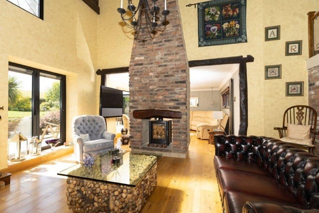 A woodburner in feature central chimney divides the two rooms.