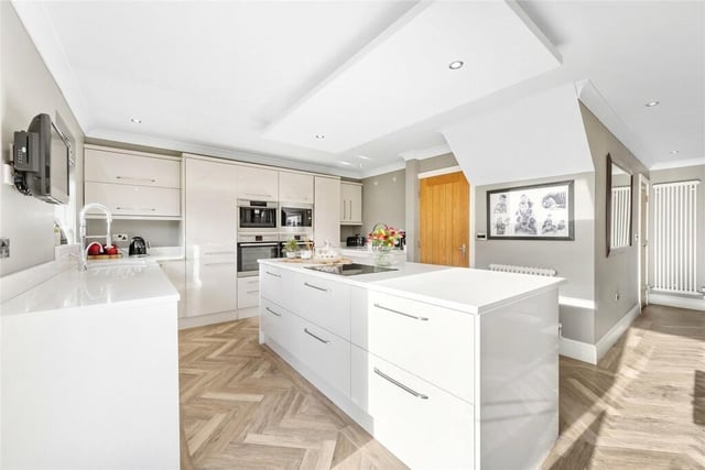 A sleek and modern kitchen with central island.