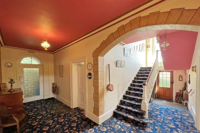 The entrance hall has a feature archway, with the staircase up to the first and second floors.