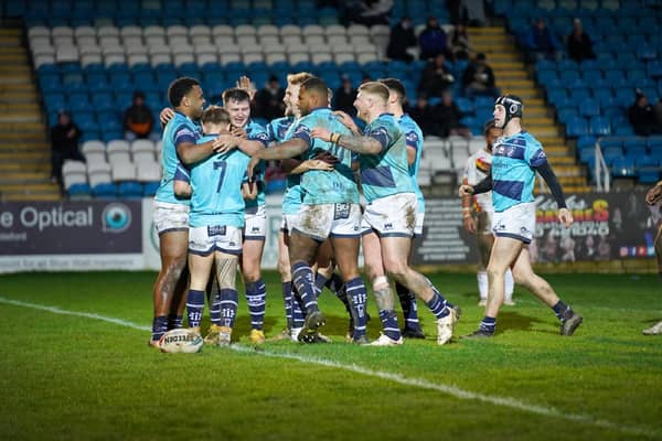 Celebration time for Featherstone Rovers players as they congratulate try scorer Thomas Lacans in the 16-12 pre-season win over Bradford Bulls. Picture: JLH Photography