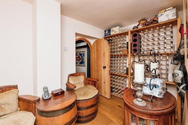 This incredible wine cellar, hidden in the basement, features engineered oak flooring, spotlights, recess understairs, and access into bedroom two.