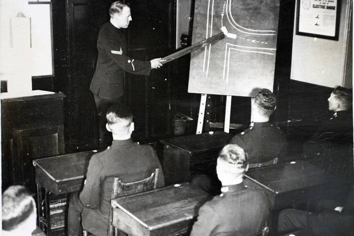 A class of constables being taught road safety in one of the classrooms of the Police University of the North, in the headquarters of the West Riding police in Wakefield, May 5 1936. The photo description says:  "The West Riding HQ gained renown as the Scotland Yard of the North but it is not generally known as a training centre for policemen and detectives. Fourteen other forces in addition to West Riding send their recruits here and forces in all parts of the country send experienced men to take the detective's course. The training is practical and even 'murders' are arranged for the students. The budding detectives have to study 'crimes', interview witnesses and make arrests."(Photo by Fox Photos/Hulton Archive/Getty Images)