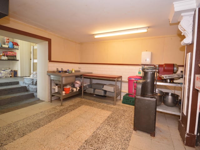 Versatile workspace leading to further storage areas.