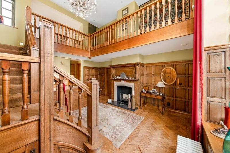 A grand entrance hallway with oak staircase and gallery landing.