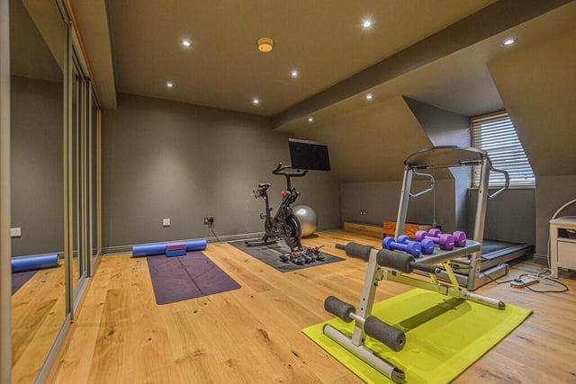A separate staircase from the snug accesses the gym which is situated above the garage, with a range of mirrored sliding wardrobes.