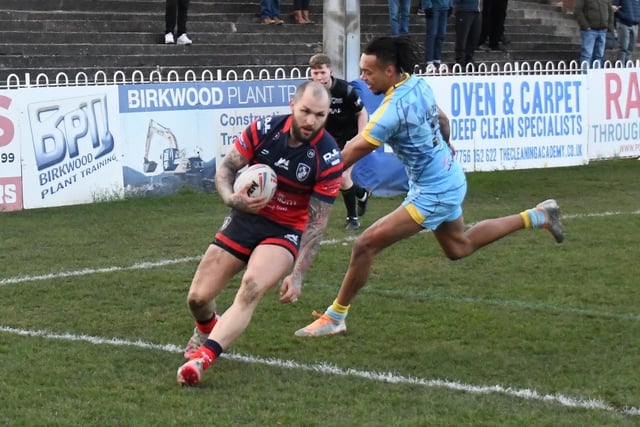 Luke Briscoe charges over the line for a try.