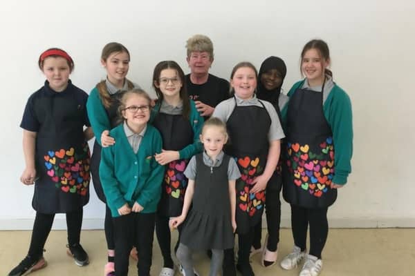 Maureen pictured with pupils from Fairburn View Primary