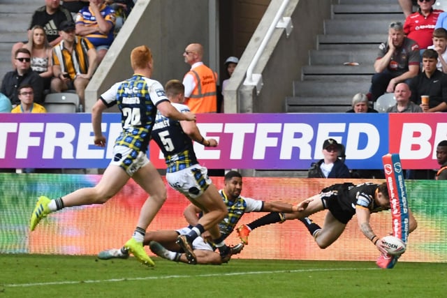 Elliot Wallis aims to dive over for a try for Castleford Tigers.