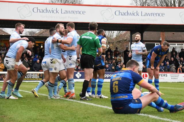Featherstone Rovers celebrate Elijah Taylor's try against Wakefield Trinity.