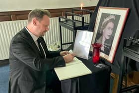 Simon Lightwood MP adding a message to a book of condolence for Queen Elizabeth II.