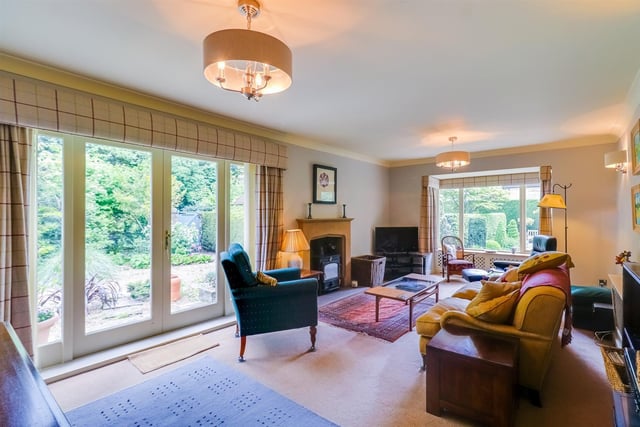 A spacious lounge with fireplace and stove, and direct access to the garden.