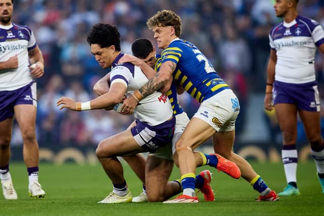 Isaiah Vagana in action with Warrington Wolves' Arron Lindop. Photo by John Clifton.