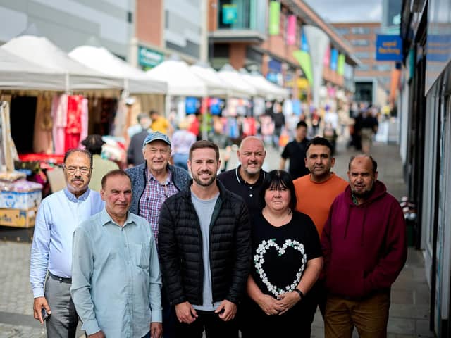 Coun Michael Graham (pictured centre), Wakefield Council's cabinet member for regeneration, with market traders on Teall Street. The council has announced that more stalls will be made available to new traders.