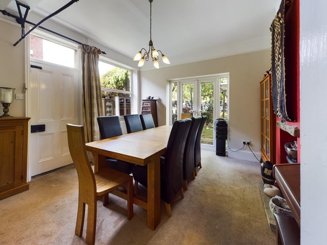 This sizeable room has an electric fire, and doors leading out to the garden.