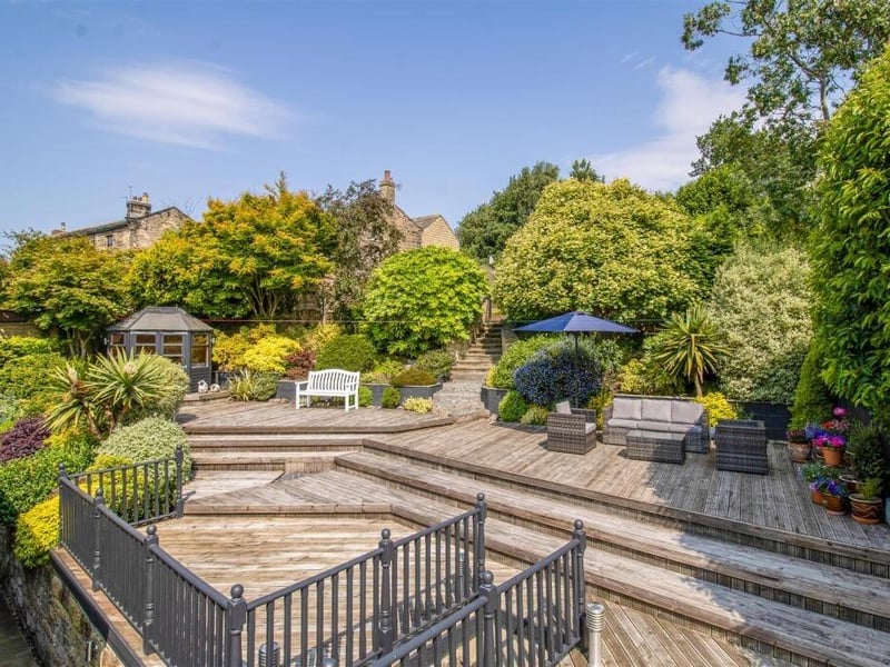To the rear, the property features a generous tiered garden, including a large timber decked terrace patio ideal for al fresco dining.