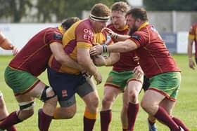 Sandal second rower Austen Thompson takes on three Heath defenders. Picture Scott Merrylees