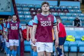 Skipper Alex Metcalfe leads the Em;ey team out fot the NCE League Cup final at Scunthorpe United's Glanford Park. Pictures: Mark Parsons