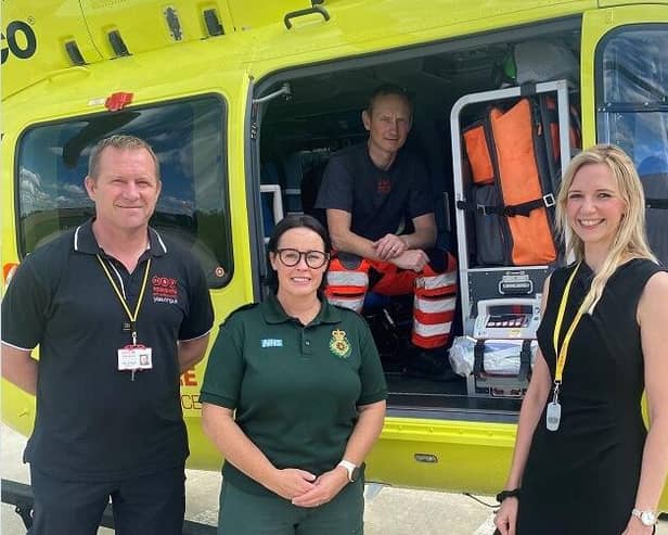 R Manager Laura Wilson with Yorkshire Air Ambulance, Armed Forces veterans, Pilot, Owen McTeggart (left), Paramedic, Fiona Blaylock (Middle), Paramedic Andrew Armitage (Inside Helicopter).