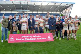 Wakefield Trinity captain Matty Ashurst is joined by his victorious teammates after being presented with the Wetherby Whaler Festive Challenge trophy. Picture: Steve Riding