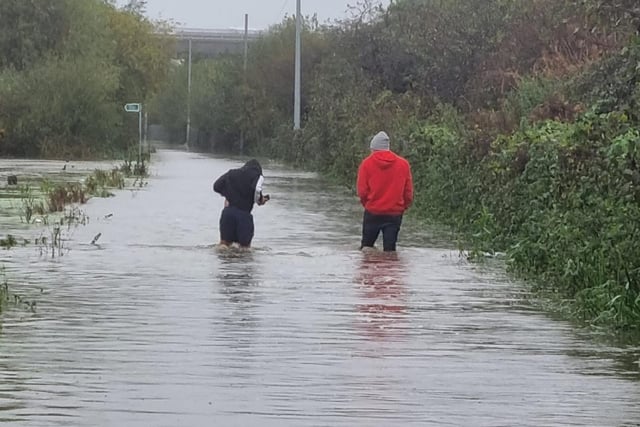 Brave locals bracing the flood.