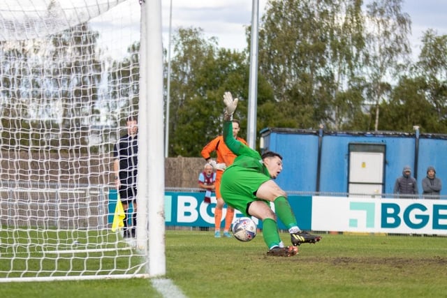 Dec Lambton dives to his left to save Vauxhall Motors' second penalty.