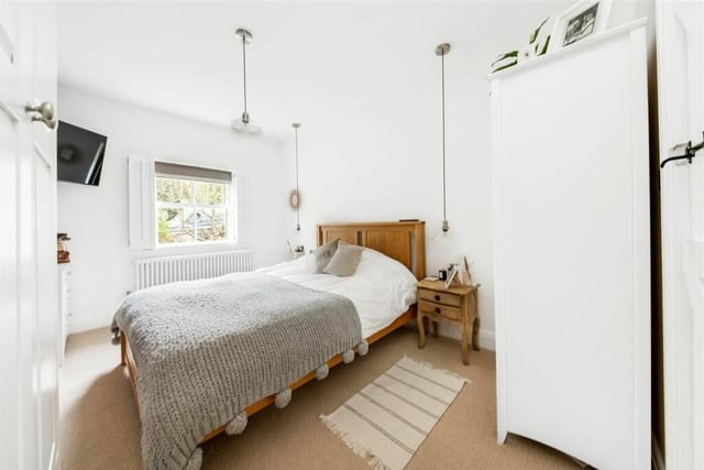 The master bedroom is a large double room with a lovely view out over the property’s front gardens, a wall of exposed stone, further loft access point, a period style central heating radiator and a doorway through to the en-suite.