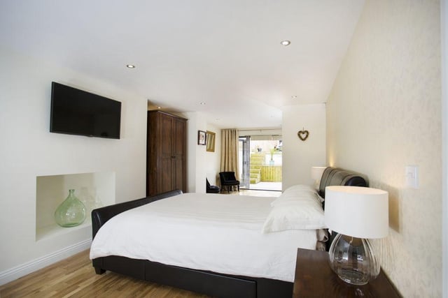 The master bedroom on the lower ground floor has a dressing room with bi-folding doors out to a private garden area.