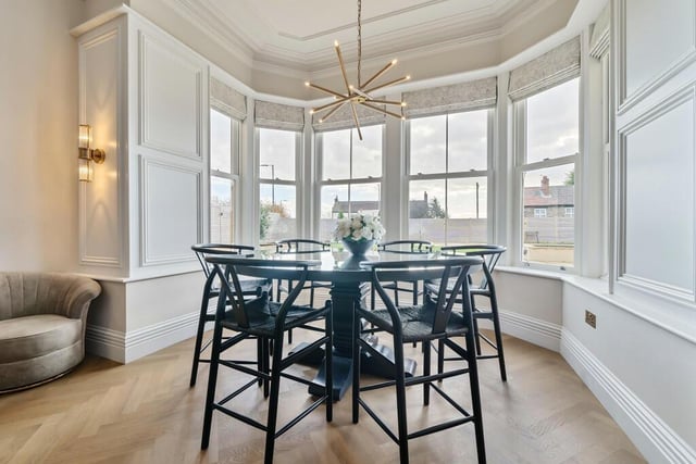 The dining area is open plan to the kitchen and sits within one of the stunning bay windows.