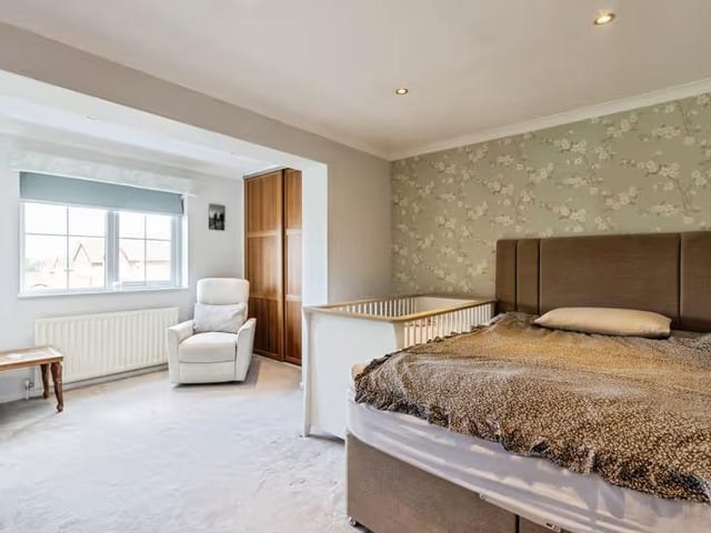 The principal bedroom has fitted wardrobes and an en suite shower room.