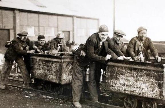 A group of miners who are members of the Castleford Rugby League team, at work on their coal tubs at the mine in Yorkshire. The tubs make excellent practice for scrum work, and the team are famed for their powers in the scrum. Photo: Photo by Fox Photos/Hulton Archive/Getty Images)