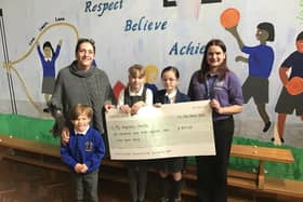 Headteacher Kim Dawson (left) and children from Rooks Nest Academy in Wakefield hand over the money raised from their annual 'colour day' to the MY Hospitals Charity which is raising money for a diagnostic suite at Pinderfields Hospital.